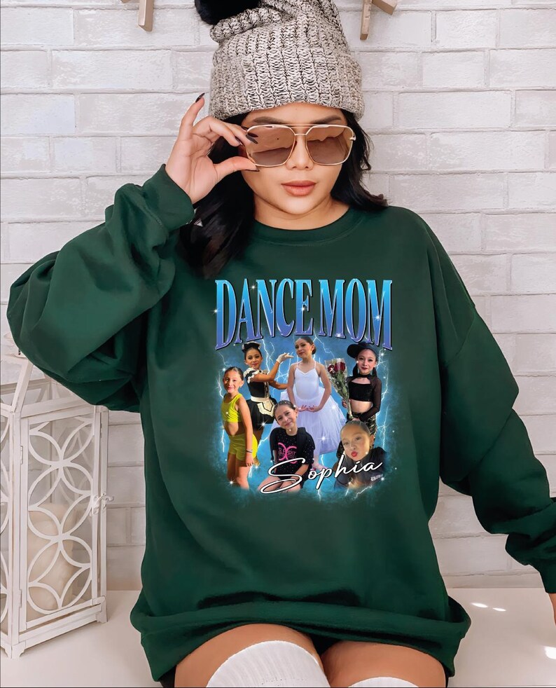 a woman wearing a green sweatshirt and a beanie