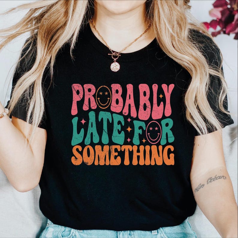 a woman wearing a black shirt that says probably later something