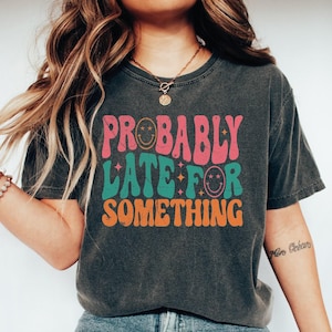 a woman wearing a t - shirt that says probably later something