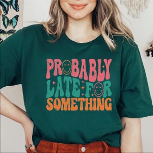 a woman wearing a green shirt that says probably water or something