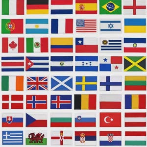 May include: A grid of embroidered flag patches, showcasing flags from around the world, including the Union Jack. The patches are rectangular with stitched edges, displaying a variety of colours and designs. The flags represent different nations.