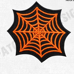 May include: Embroidered spiderweb patch in black and orange. The patch showcases an orange spiderweb design against a black backdrop. The patch has a distinctive, pointed shape, ideal for Halloween or themed crafts.
