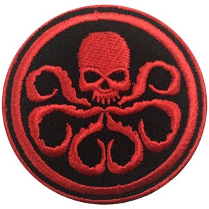 May include: Embroidered patch featuring a red skull with tentacles, encircled by a red border on a black background. The design is a stylized representation of a skull and tentacles.