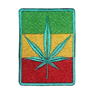 May include: Embroidered patch featuring a cannabis leaf in turquoise, centered on a rectangular background. The background is divided into three horizontal stripes: green, yellow, and red, with a turquoise border.