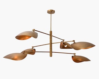 May include: A brass chandelier with five curved shades. The shades are arranged in a symmetrical pattern around a central rod.