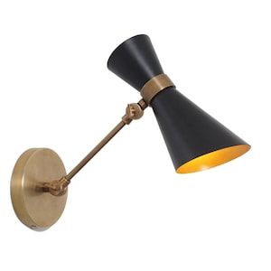 May include: A black and brass wall sconce with a swiveling arm and a cone-shaped shade. The shade has a gold interior.