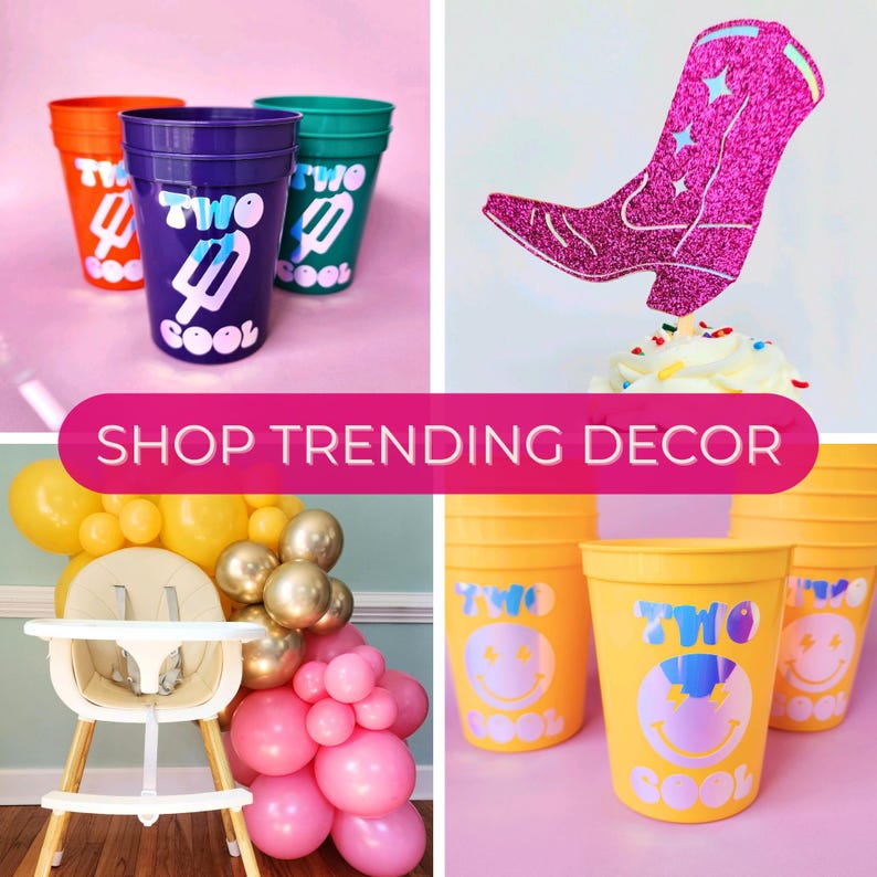 May include: Two Cool themed party decorations, including a pink cowboy boot cupcake topper, a white high chair, and yellow and pink balloons. There are also several plastic cups with the words "Two Cool" and a smiley face design.