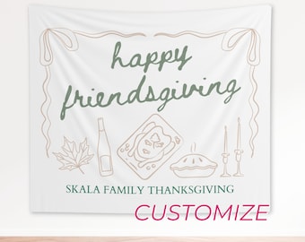 May include: White Friendsgiving tapestry with a decorative border and illustrations of a leaf, bottle, turkey, pie, and candles. The words "happy friendsgiving" are in green script, with "Skala Family Thanksgiving" below.