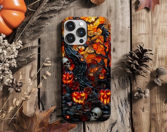 May include: A black phone case with a Halloween-themed design. The case features a stained glass style image of a tree with pumpkins, skulls, and bats. The phone case has a camera lens cutout and a black border.