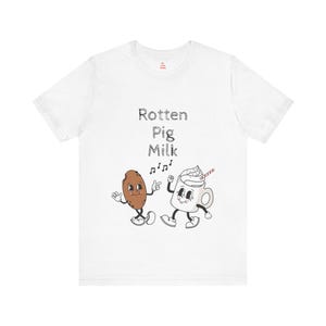 Könnte beinhalten: Weißes T-Shirt mit einem Grafikdruck eines Kekses und eines Milchshakes, die tanzen. Der Text "Rotten Pig Milk" befindet sich über dem Grafikdruck.