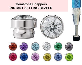 May include: Gemstone Snappers Instant Setting Bezels, a set of 12 colorful gemstone bezels in various colors, including red, blue, green, purple, and yellow. The bezels are designed to be used with a setting tool, which is also pictured.