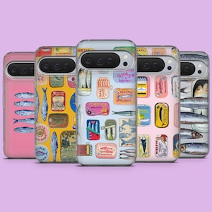 May include: A collection of five phone cases with sardine-themed designs. The cases feature various illustrations of sardines, sardine cans, and related text in a variety of colors, including pink, yellow, and blue. The cases are displayed against a light purple background.