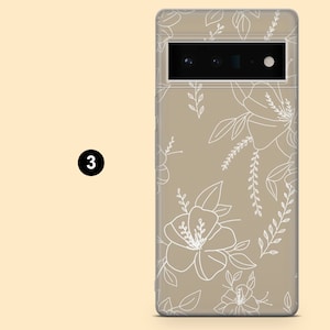 May include: A beige phone case with a white floral design. The case has a clear back and a raised camera bump.