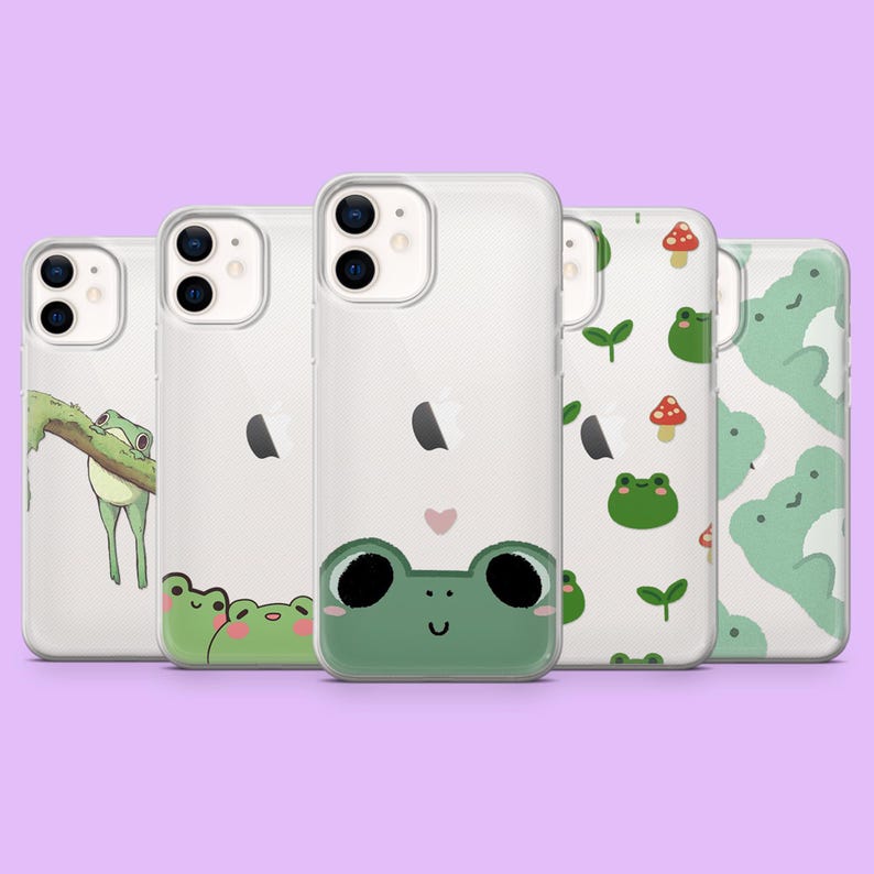 May include: Five different phone cases with frog designs. The cases are clear and have a variety of frog illustrations, including a frog on a branch, a frog with a heart, and a frog with a crown.