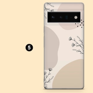 May include: A clear phone case with a beige background and abstract shapes. The case has a black line drawing of flowers and leaves.
