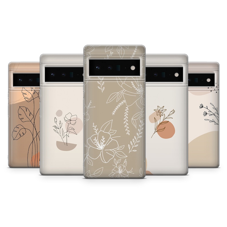 May include: Five phone cases with different floral designs. The cases are all clear and have a white floral pattern on a beige background. The cases are all lined up in a row.