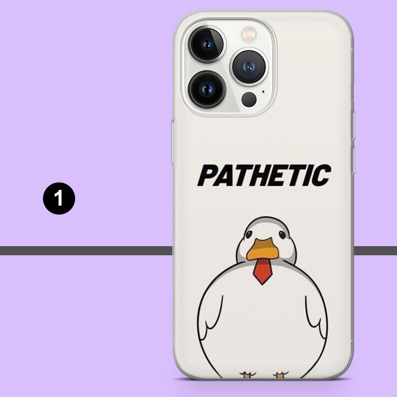May include: A white iPhone case with a cartoon duck wearing a red tie and the word "PATHETIC" printed on it.