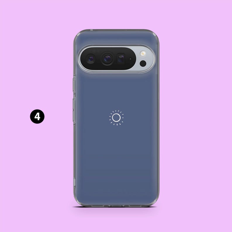 May include: A clear phone case with a blue-gray backing. The case has a camera cutout at the top and a white sun-like graphic in the center. The phone case is designed to fit a specific phone model.