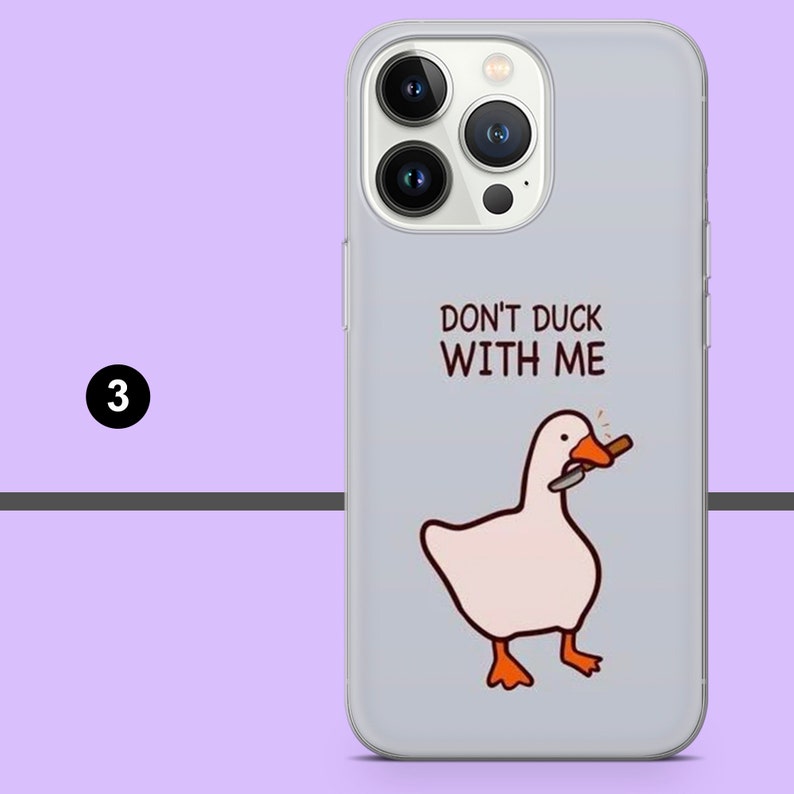 May include: A gray phone case with a white goose holding a knife in its beak. The text "Don't duck with me" is printed on the case.