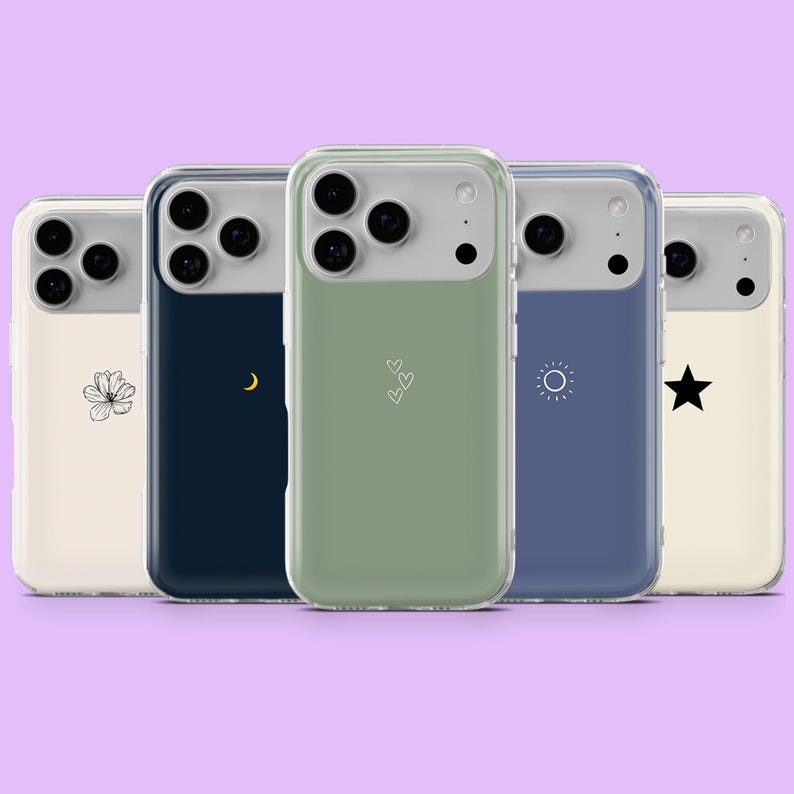 May include: Five phone cases with different designs. The cases have a clear border and a light gray top. The designs include a flower, a crescent moon, three hearts, a sun, and a star. The background is a light purple.