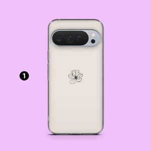 May include: A clear phone case with a floral design. The case has a light beige background with a black and white flower in the center. The phone's camera is visible at the top.