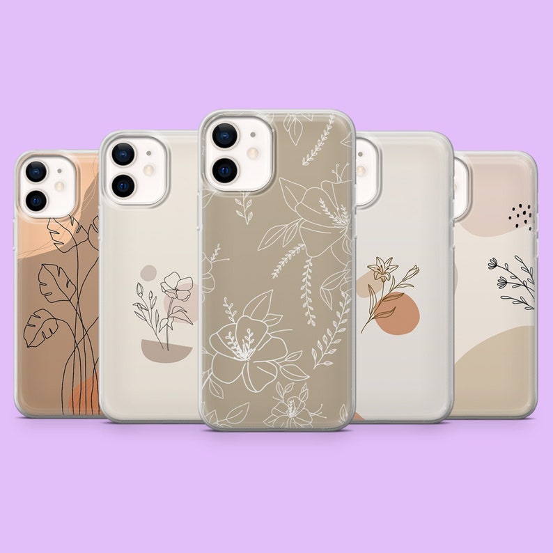 May include: Set of five clear phone cases with different minimalist floral designs. The cases are beige with white line drawings of flowers and leaves.