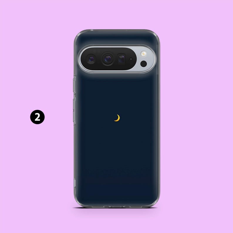 May include: A navy blue phone case with a clear border. The case features a gold crescent moon design. The phone's camera is visible at the top. The number "2" is in a black circle on the left side.