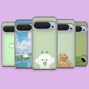 May include: A collection of five phone cases with various frog-themed designs. The cases are light green and feature illustrations of frogs in different settings, including a pond scene and a frog reading a book. The cases are arranged in a row.