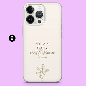 May include: White phone case with a gold design that says "You are God's masterpiece" and "Ephesians 2:10". The design also includes a small floral illustration.