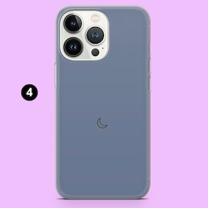 May include: A clear phone case with a blue tint and a crescent moon design. The case is designed for a smartphone with a triple camera system.