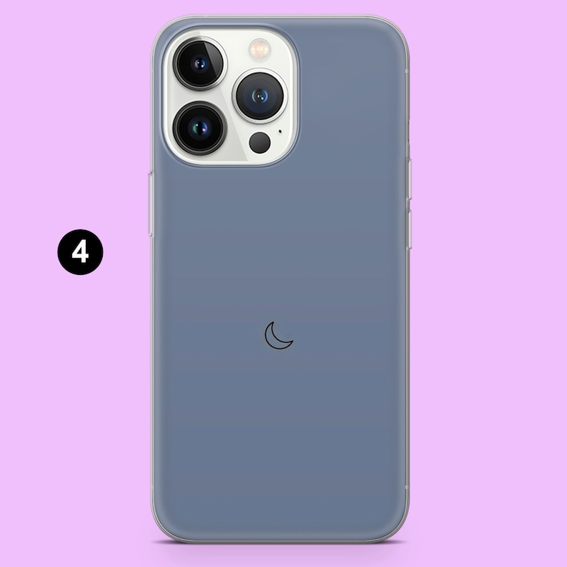 May include: A clear phone case with a blue tint and a crescent moon design. The case is designed for a smartphone with a triple camera system.