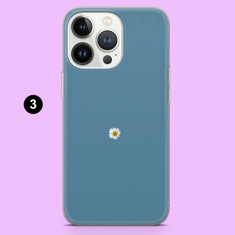 May include: A blue phone case with a white daisy design. The case is made for an iPhone 14 Pro.