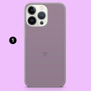 May include: A clear phone case with a light purple tint and a small heart design. The case is designed for an iPhone.