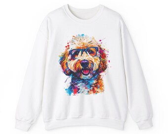 May include: White sweatshirt with a colorful graphic print of a dog wearing glasses. The dog is a doodle breed with brown fur and a white face. The background of the graphic is a watercolor-style design with splashes of color.