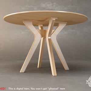 May include: A round wooden table with a light-colored top and a unique base design. The table's legs are made of light wood and have a curved, architectural shape. The table is approximately 30 inches in diameter.