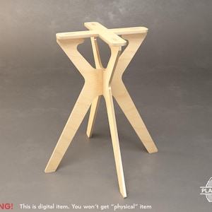 May include: A light-colored wooden table base with a unique, geometric design. The base features four angled legs that converge towards the floor, supporting a cross-shaped top. The text "WARNING! This is digital item. You won't get "physical" item" is visible.