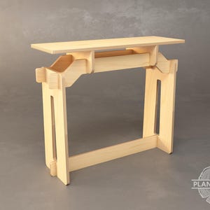 May include: A light wood standing desk with a simple design. The desk is made of plywood and has a rectangular top. The desk is adjustable in height and can be used as a standing or sitting desk.