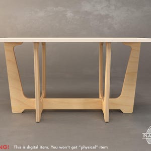 Puede incluir: Una mesa con una superficie blanca y una base de madera clara. La base tiene un diseño único con patas anguladas y un marco rectangular.