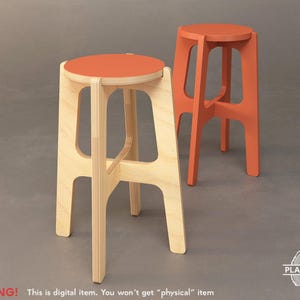 May include: Two wooden stools with a simple design. One stool is natural wood with an orange seat, and the other stool is painted orange.