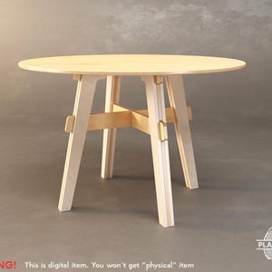May include: A light wood round table with a simple design. The table has four legs that are connected by a cross-shaped support beam. The table is made of plywood and has a natural wood finish.