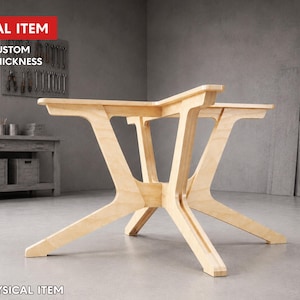 May include: A light-coloured wooden table base with a unique, modern design. The base features angled legs and a sturdy frame, suitable for supporting a tabletop. The image includes the text "DIGITAL ITEM" and "FREE CUSTOM SIZE & THICKNESS".