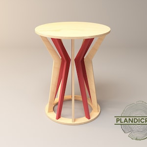 May include: A wooden side table with a round top and red painted legs. The legs are designed in a geometric pattern.
