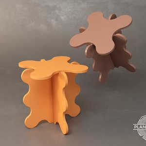 Peut inclure: Deux tabourets en bois aux formes organiques uniques. Le tabouret de gauche est orange et celui de droite est brun.