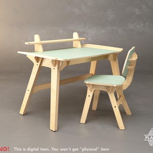 May include: A light wood children's desk and chair set. The desk has a light green top and a shelf. The chair has a matching light green seat and back. The set is made of light-colored wood. The desk measures approximately 30 inches wide.