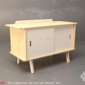 May include: A light-coloured wooden cabinet with sliding doors and angled legs. The cabinet has a rectangular shape with a small shelf on top. The doors have vertical cut-out handles. The text "WARNING! This is digital item. You won't get "physical" item" is visible.