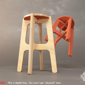 May include: A wooden stool with a natural finish and a round seat. The stool is made of plywood and has a simple, modern design. The stool is shown next to a smaller, orange-coloured stool.