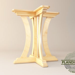 May include: A wooden table base with four legs that are curved and joined together at the bottom. The base is made of light-colored wood and has a simple, modern design.