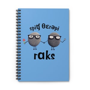 May include: A blue spiral notebook with a cartoon image of two gray rocks wearing sunglasses and holding hands. The text "spit therapy raks" is printed on the notebook.