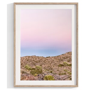 A wall art set of 3 framed or unframed Joshua Tree National Park prints.  This desert wall art showcases a stunning Joshua Tree and the desert terrain and plants in a breathtaking Pink sunset filled with Pink and Purple hues. Modern gallery wall set