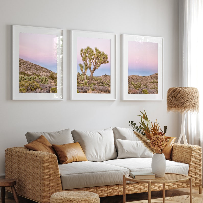 A wall art set of 3 framed or unframed Joshua Tree National Park prints.  This desert wall art showcases a stunning Joshua Tree and the desert terrain and plants in a breathtaking Pink sunset filled with Pink and Purple hues. Modern gallery wall set